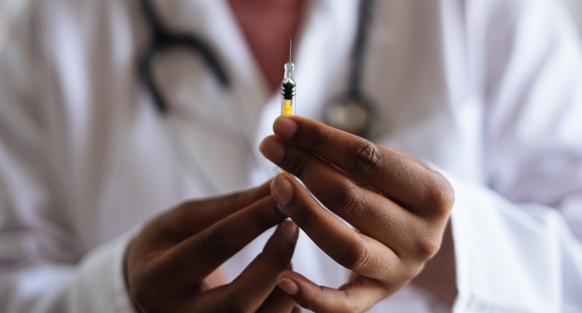 A doctor holding a syringe