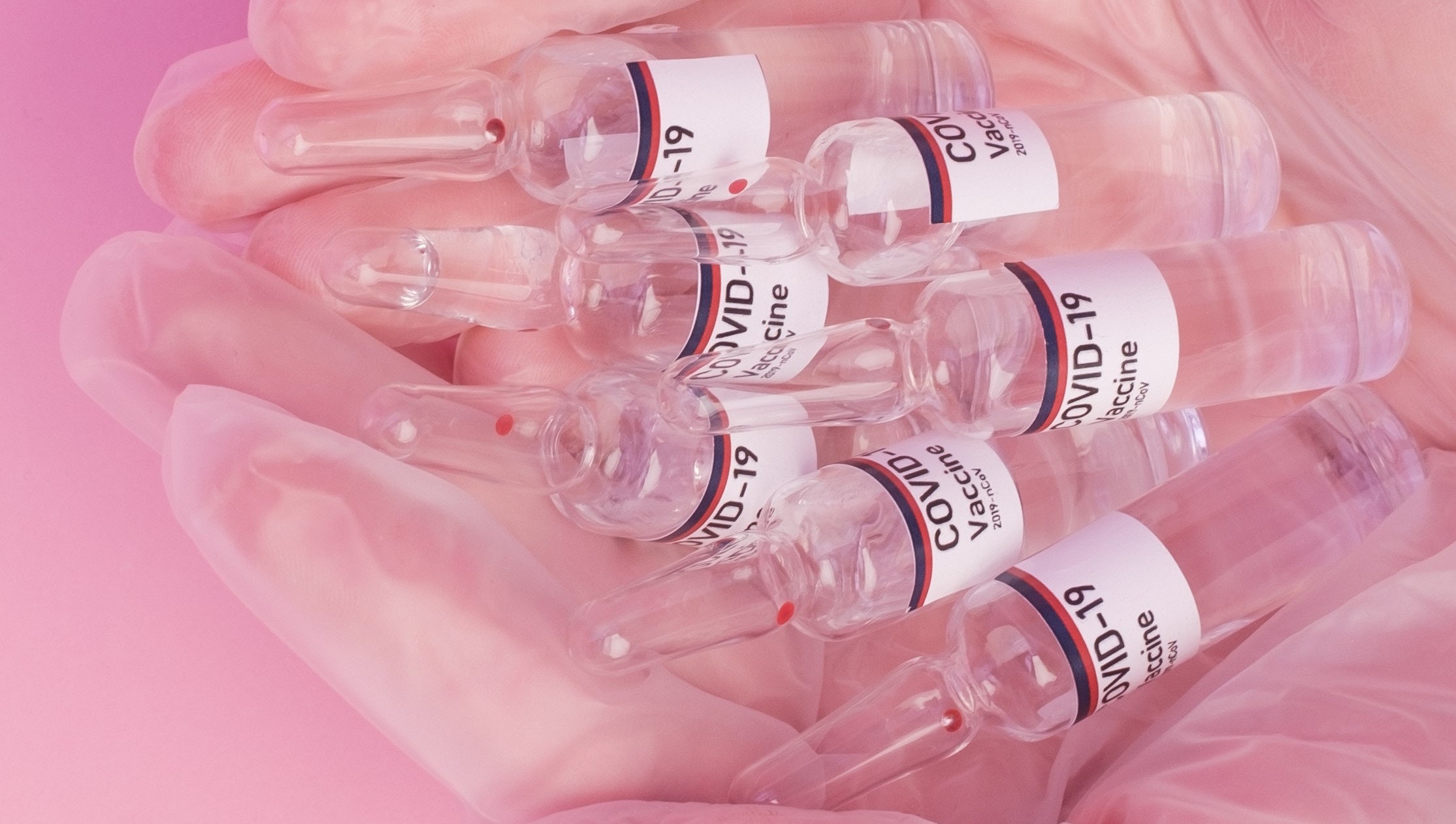 Vials of COVID-19 vaccine in a hand